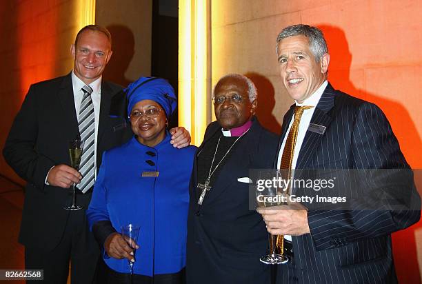 Archbishop Emeritus Desmond Tutu is welcomed by Hendrik du Toit, CEO of Investec Asset Management, during the Investec Asset Management, Africa...