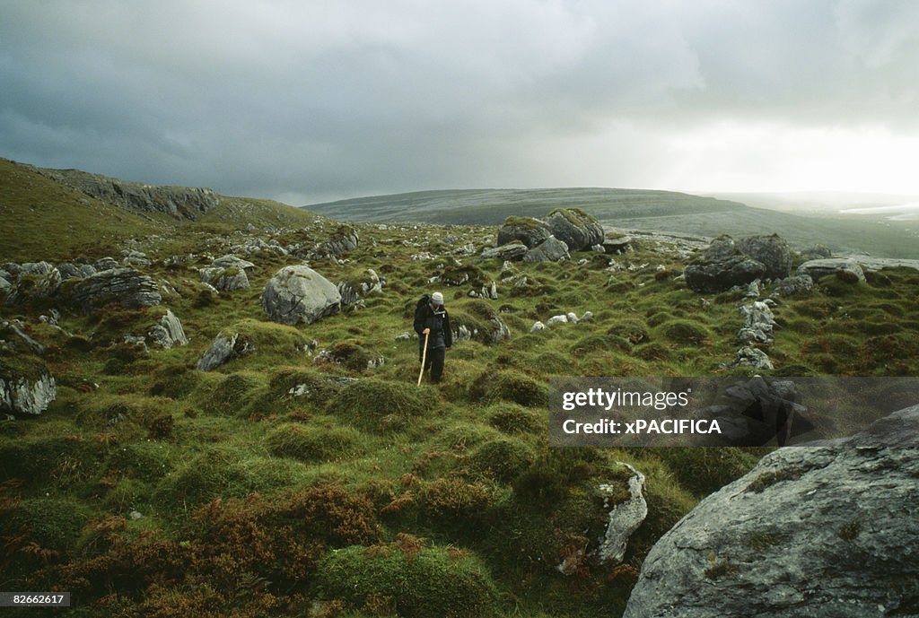 A man hiking in the Burren in Ireland.