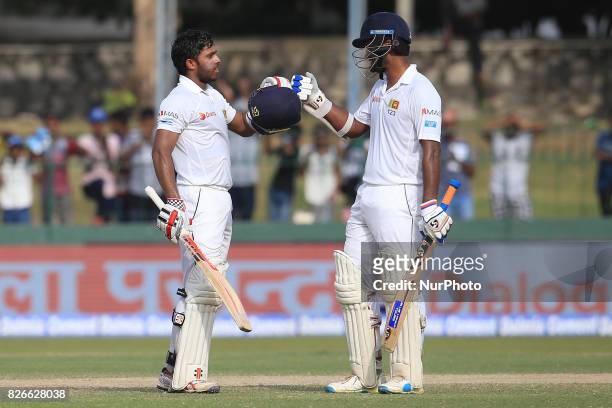Sri Lankan cricketer Dimuth Karunaratne joins in to celebrate after Kusal Mendis scored a century during the 3rd Day's play in the 2nd Test match...