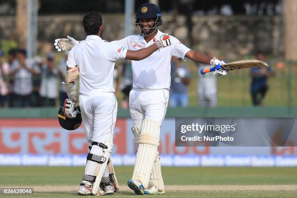 Sri Lankan cricketer Dimuth Karunaratne joins in to celebrate after Kusal Mendis scored a century during the 3rd Day's play in the 2nd Test match...