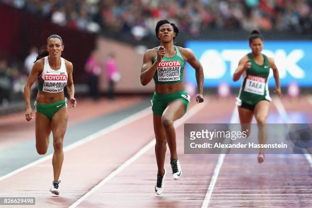 Blessing Okagbare of Nigeria and Ivet Lalova-Collio of Bulgaria competes in the Women's 100 metres heats during day two of the 16th IAAF World...