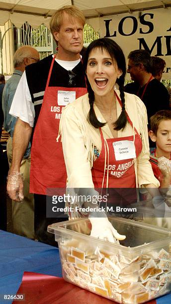 Actress Connie Sellecca and her husband John Tesh attend the "Thanksgiving Day Meal" for the homeless at the Los Angeles Mission November 21, 2001 in...