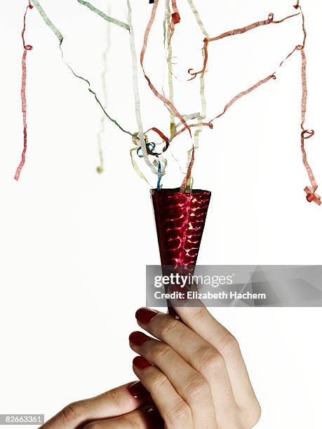 hands pulling a party popper - party popper stock pictures, royalty-free photos & images