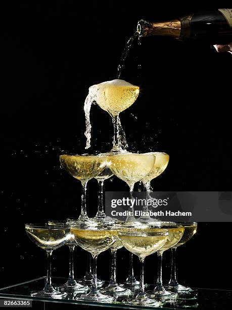 hand pouring a champagne fountain - champagne celebration stock pictures, royalty-free photos & images