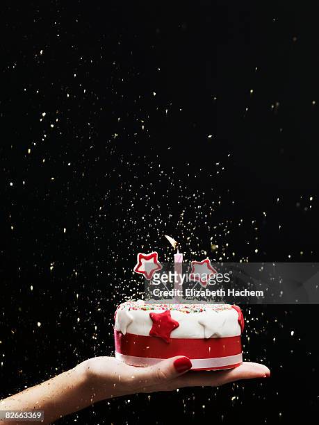 hand holding out small cake - holding birthday cake stock pictures, royalty-free photos & images