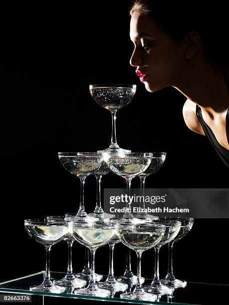 girl sipping from champagne fountain - champagne pyramid stock pictures, royalty-free photos & images