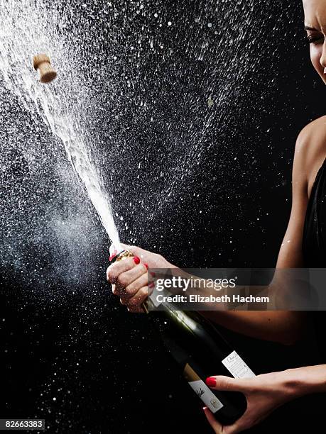 girl shaking up bottle of champagne - spraying champagne stock pictures, royalty-free photos & images