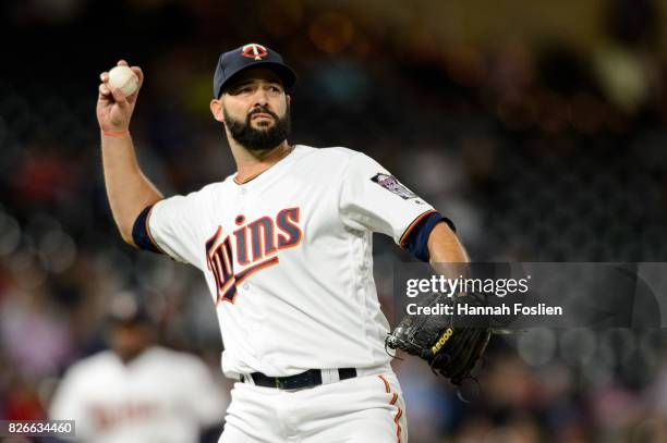 Dillon Gee of the Minnesota Twins throws the ball to first base against the Texas Rangers during the game on August 3, 2017 at Target Field in...