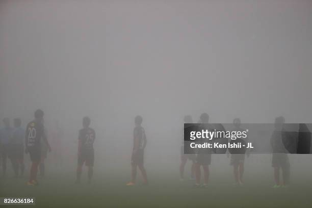 Kashima Antlers players stand as the match is suspended due to the heavy fog during the J.League J1 match between Kashima Antlers and Vegalta Sendai...