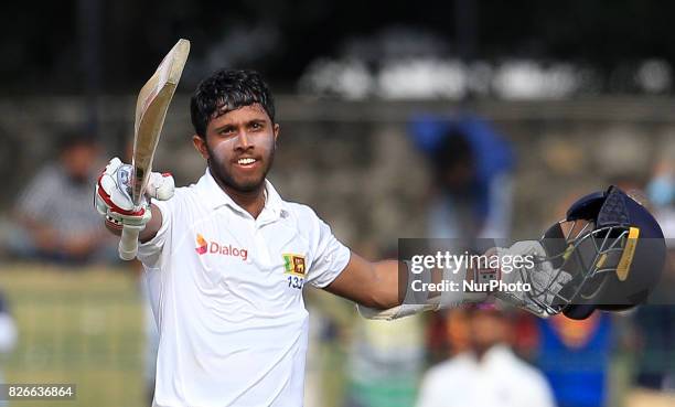 Sri Lankan cricketer Kusal Mendis celebrates after scoring 100 runs during the 3rd Day's play in the 2nd Test match between Sri Lanka and India at...