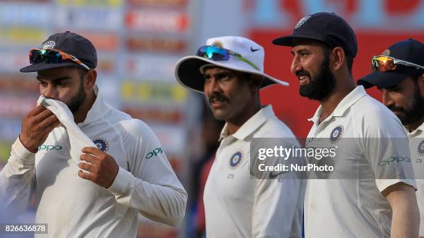 Indian cricket captain Virat Kohli , Ravindra Jadeja , Cheteshwar Pujara walk off at the end of 3rd Day's play in the 2nd Test match between Sri...