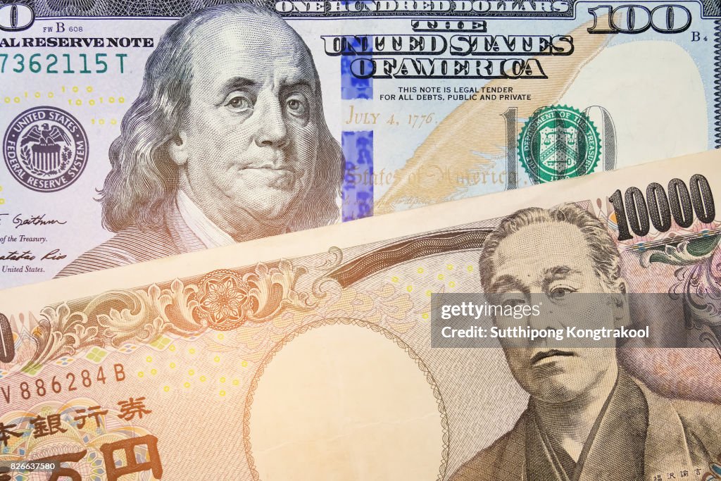 Japanese Yen and USD Dollar Bank note pile, Business and finance concept. 10,000 Japanese Yen and 100 dollar BankNote. Money background.currency exchange rate