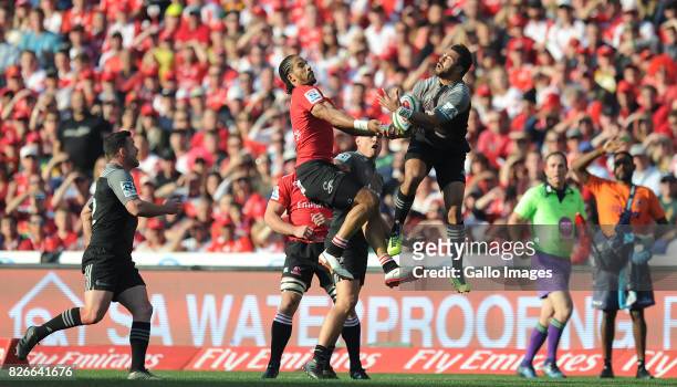 Courtnall Skosan of Lions is tackled by Richie Mounga of Crusaders during the Super Rugby Final match between Emirates Lions and Crusaders at...