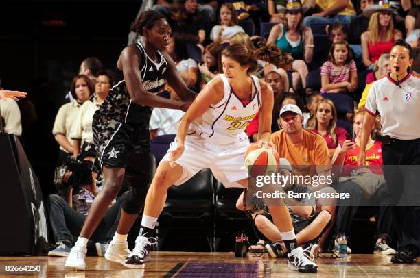 Brooke Smith of the Phoenix Mercury moves the ball against Sophia Young of the San Antonio Silver Stars during a game at U.S. Airways Center on...