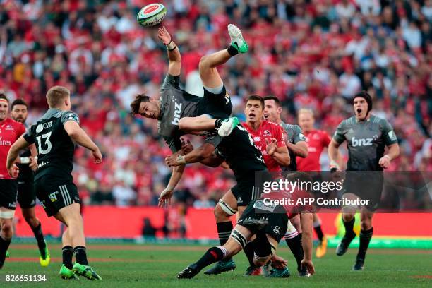 Crusaders's New Zealand midfielder David Havili collides with Lions' South African winger Kwagga Smith during the Super XV rugby final match between...