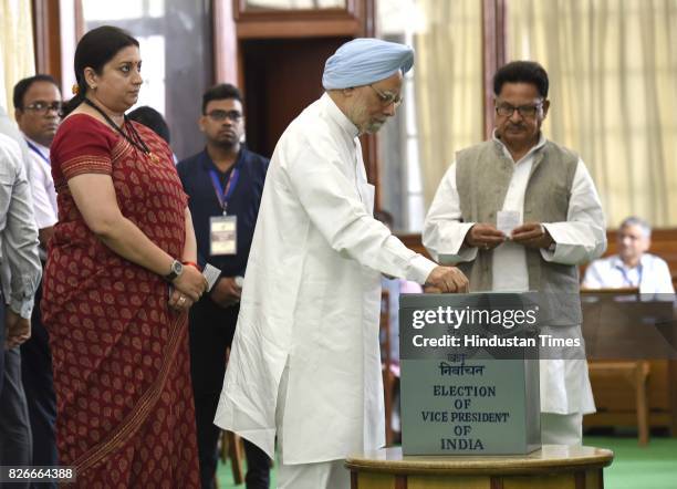 Former Prime Minister Manmohan Singh with Smriti Irani, Union Minister for I&B, casts his vote for Vice Presidential Election, at Parliament House,...