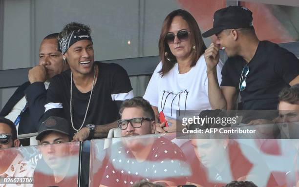 Paris Saint-Germain's Brazilian forward Neymar , chats with his close friend Jo Amancio as his father Neymar Santos , and mother Nadine Santos look...