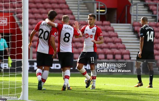 Manolo Gabbiadini celebrates with Steven Davis and Dusan Tadic after scoring Southampton's second during the pre-season friendly between Southampton...