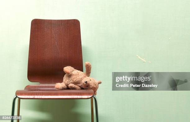 childs forgotten, abandoned teddy on chair - sad child hospital stock pictures, royalty-free photos & images