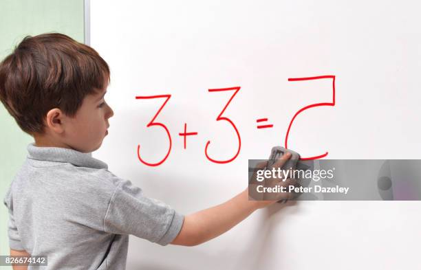 dyslexic child erasing incorrect maths answer - thinking outside the box englische redewendung stock-fotos und bilder