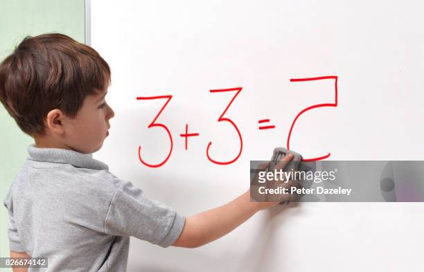 dyslexic child erasing incorrect maths answer - reversing stock pictures, royalty-free photos & images