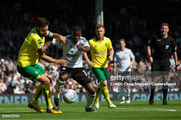 Fulham's Floyd Ayite battles for possession with Norwich City's Russell Martin during the Sky Bet Championship match between Fulham and Norwich City...