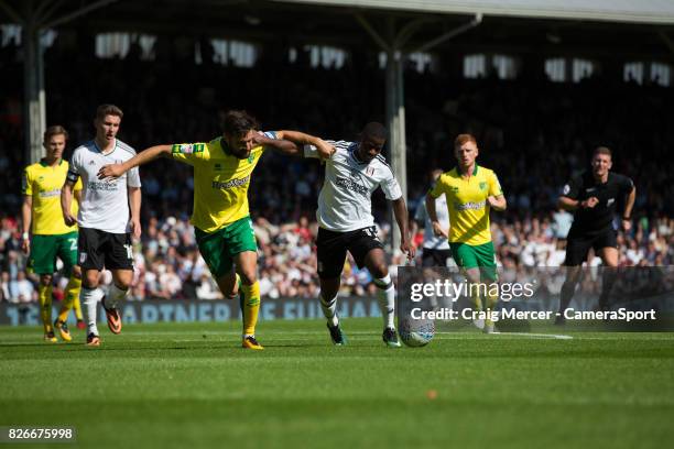 Fulham's Floyd Ayite battles for possession with Norwich City's Russell Martin during the Sky Bet Championship match between Fulham and Norwich City...