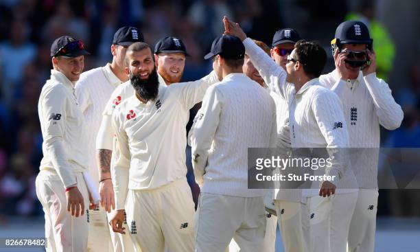 England bowler Moeen Ali celebrates with team mates after taking the wicket of Mahraj during day two of the 4th Investec Test match between England...