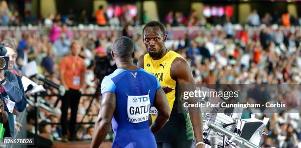 Usain Bolt of Jamaica shock reaction to Justin Gatling of the USA while giving media interviews after winning Heat 6 of Round 1 of the Men's 100...