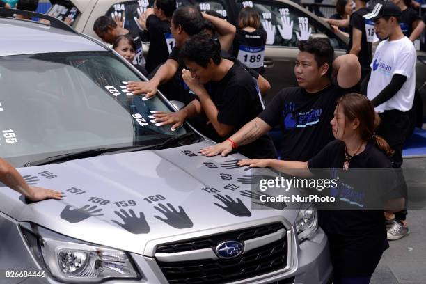 Participant with hand placed on a car during of the Subaru Palm Challenge in Bangkok, Thailand, on August 5, 2017. Subaru Palm Challenge Thailand...