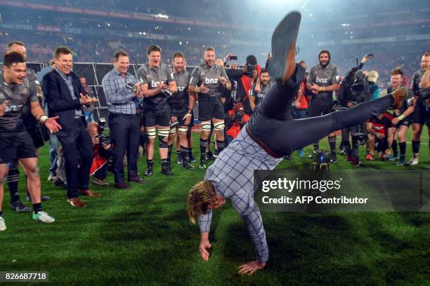 Crusaders's New Zealand head coach Scott Robertson dances as he celebrate with his team during the price ceremony after winning the Super XV rugby...