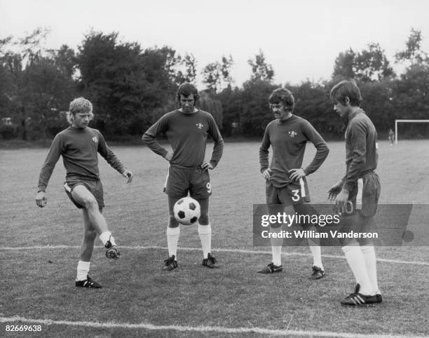 Chelsea Internationals Peter Osgood and Eddie McCreadie watch as the newly signed Wilkins brothers, 17 year-old Graham and 15 year-old Ray, show off...