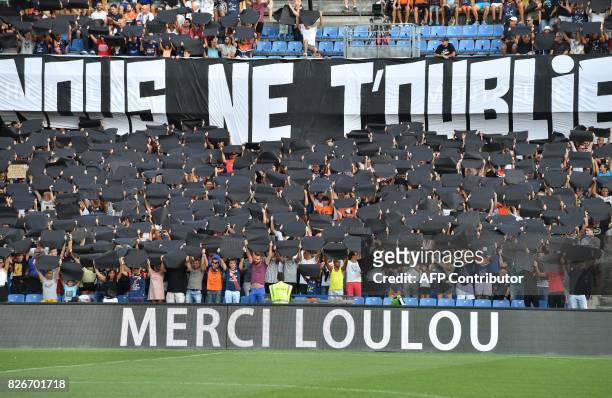 Montpellier supporters hold banners in tribute to Montpellier's late president Louis Nicollin prior to the French L1 football match between...