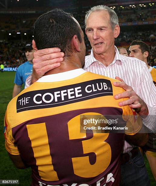 Broncos coach Wayne Bennett and Tonie Carroll of the Broncos embrace after the round 26 NRL match between the Brisbane Broncos and the Newcastle...