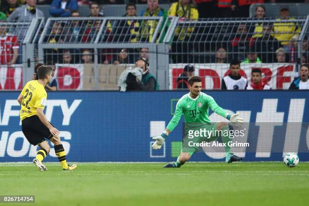 Christian Pulisic of Dortmund scores his team's first goal past goalkeeper Sven Ulreich of Muenchen during the DFL Supercup 2017 match between...