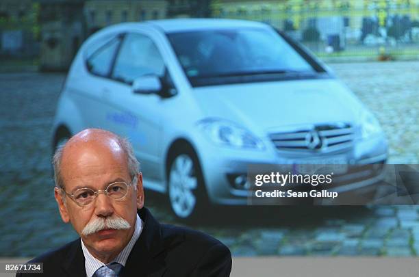 Daimler head Juergen Zetsche speaks in front of a picture of an electric-powered Smart car during a presentation of the e-mobility project on...
