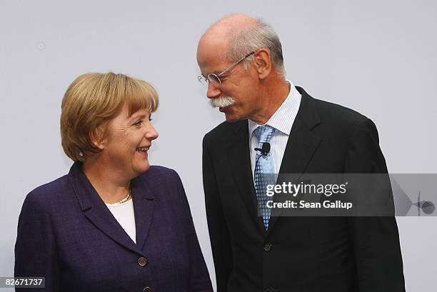 Daimler head Juergen Zetsche chats with German Chancellor Angela Merkel during a presentation of the e-mobility project on September 5, 2008 in...