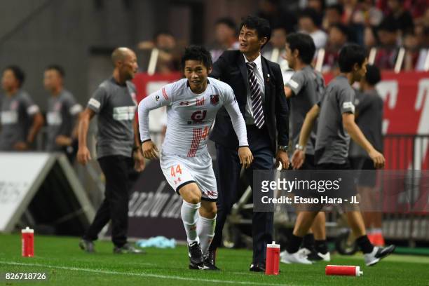 Yusuke Segawa of Omiya Ardija celebrates scoring his side's second goal with head coach Akira Ito during the J.League J1 match between Urawa Red...