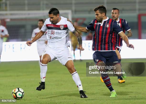 Leandro Cabrera of Crotone competes for the ball with Marco Borroello of Cagliari during the Pre-Season Friendly match between FC Crotone and...