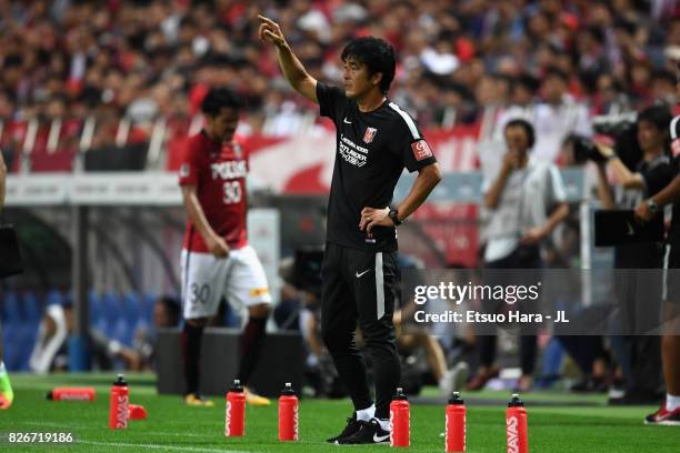 Head coach Takafumi Hori of Urawa Red Diamonds gestures during the J.League J1 match between Urawa Red Diamonds and Omiya Ardija at Saitama Stadium...