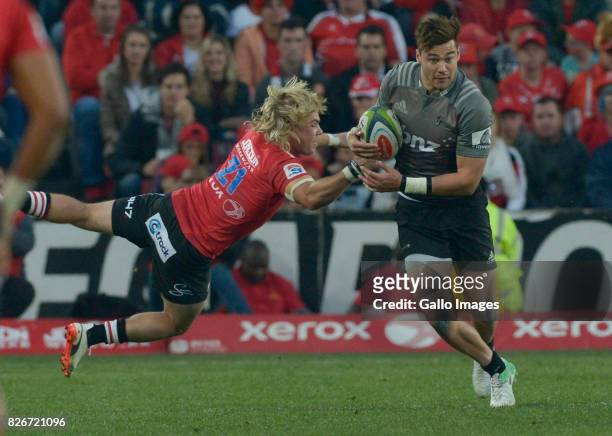 David Havili of the Crusaders tackled by Faf de Klerk of the Lions during the Super Rugby Final match between Emirates Lions and Crusaders at...