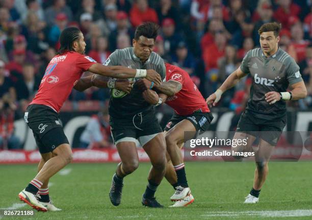 Seta Tamanivalu of the Crusaders tackled by Lionel Mapoe of the Lions and Courtnall Skosan of the Lions during the Super Rugby Final match between...