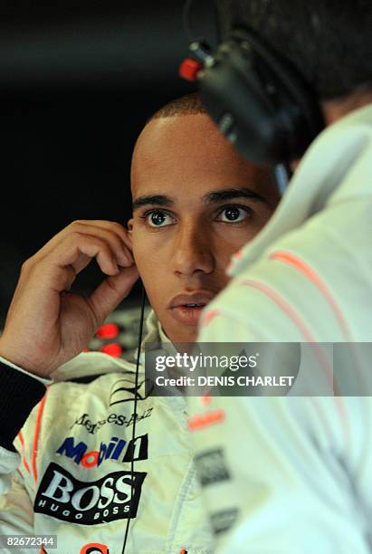 McLaren Mercedes' British driver Lewis Hamilton puts his earplugs in the pits of the Spa-Francorchamps racetrack on September 5 during the second...