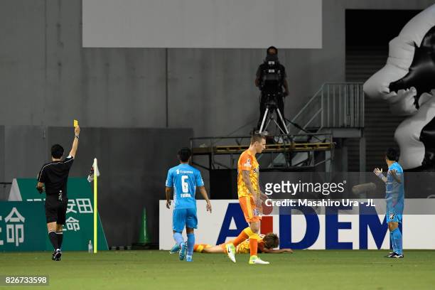Yoshiki Takahashi of Sagan Tosu is shown a yellow card by referee hajime Matsuo during the J.League J1 match between Sagan Tosu and Shimizu S-Pulse...