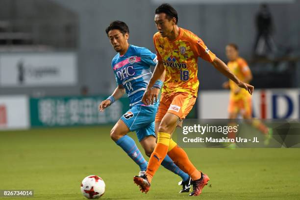 Yu Hasegawa of Shimizu S-Pulse controls the ball under pressure of Yoshiki Takahashi of Sagan Tosu during the J.League J1 match between Sagan Tosu...