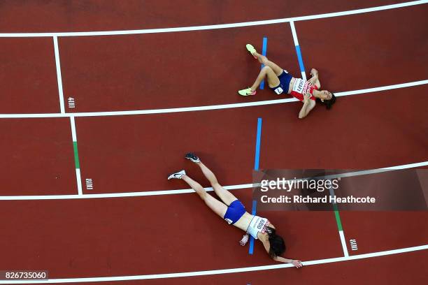 Rabebe Arafi of Morrocco and Jessica Judd of Great Britain lay on the track following the Women's 1500 metres semi final during day two of the 16th...