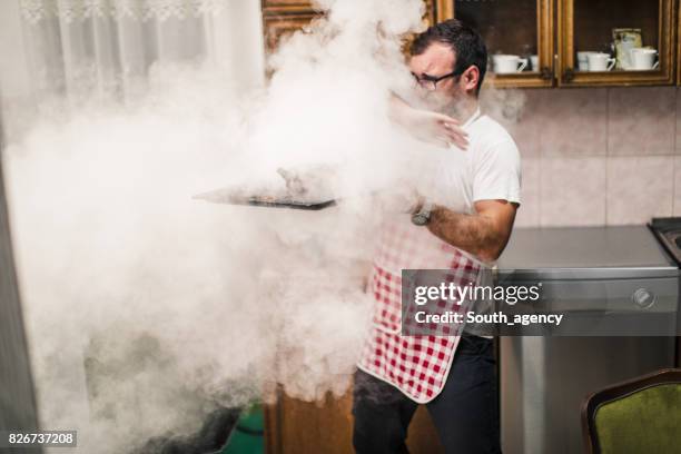 man making dinner - burnt chicken stock pictures, royalty-free photos & images