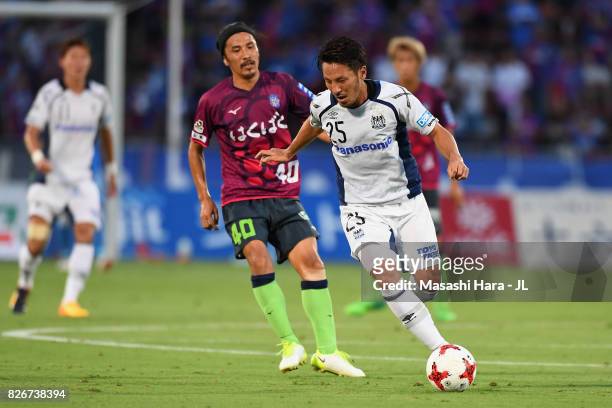 Jungo Fujimoto of Gamba Osaka controls the ball under pressure of Shohei Ogura of Ventforet Kofu during the J.League J1 match between Ventforet Kofu...