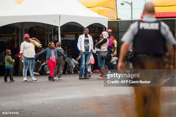 Refugees who crossed the Canada/US border illegally wait in a temporary detention centre in Blackpool, Quebec, August 5, 2017. Canadian Prime...
