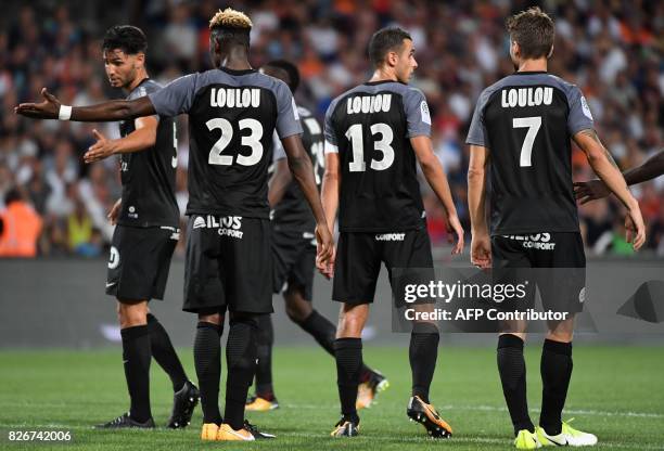 Montpellier's players with jerseys where is written "Loulou", the nickname of the late president of the club of Montpellier Louis Nicollin, react...